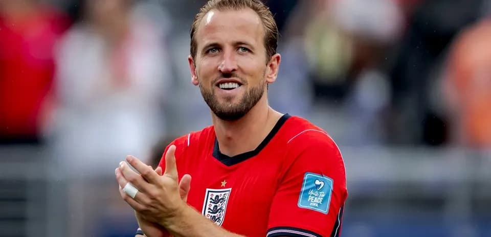 Player applauding in red England jersey on pitch