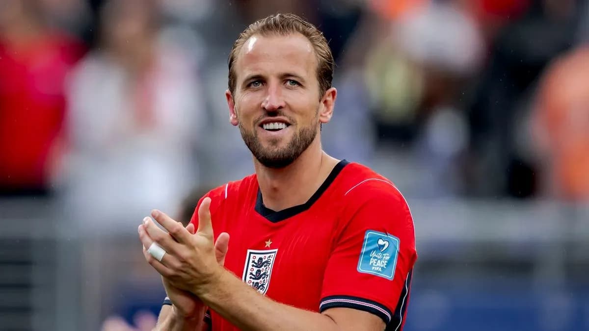 Player applauding in red England jersey on pitch