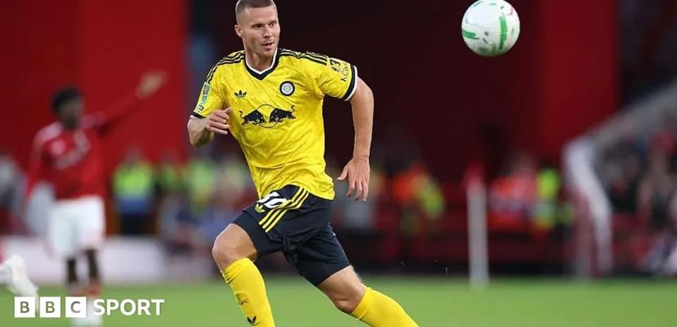 Player in yellow kit controlling a soccer ball