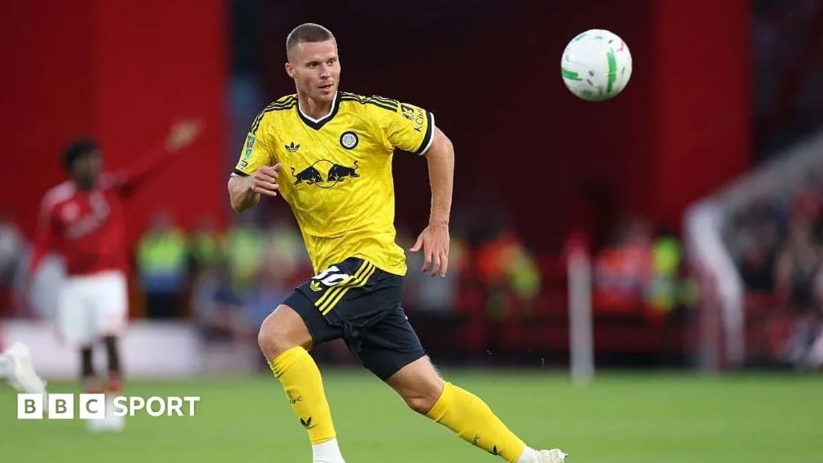 Player in yellow kit controlling a soccer ball