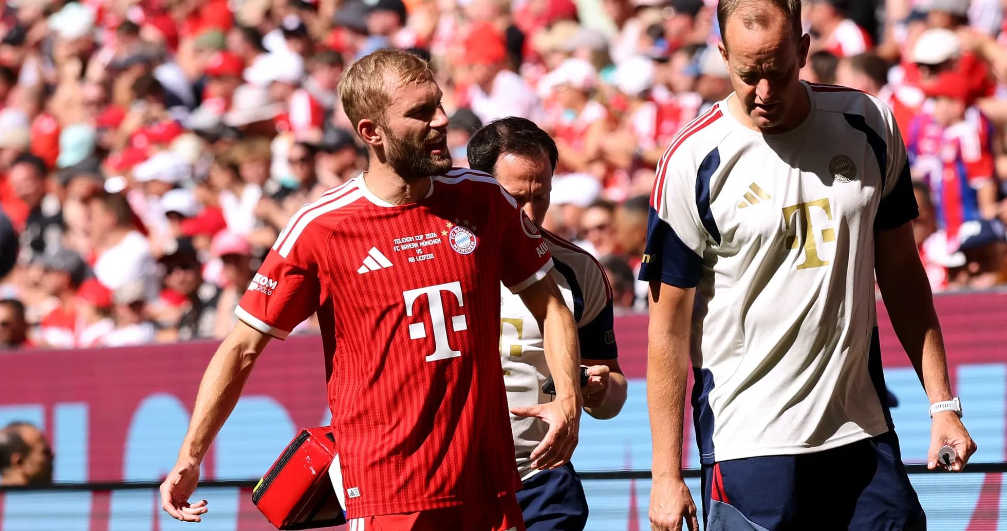 Bayern Munich player leaving field with medical staff