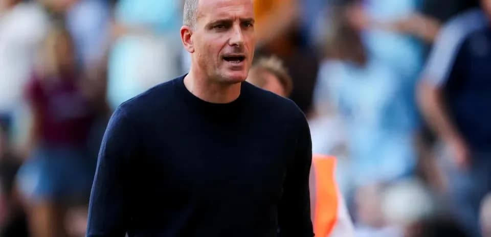 Coach speaking during a match on the sidelines