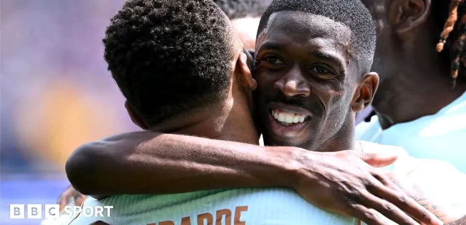 Players celebrating with a hug during match