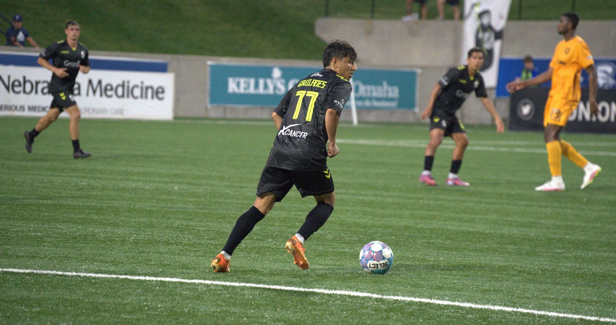 Player dribbling the ball during Union Omaha match