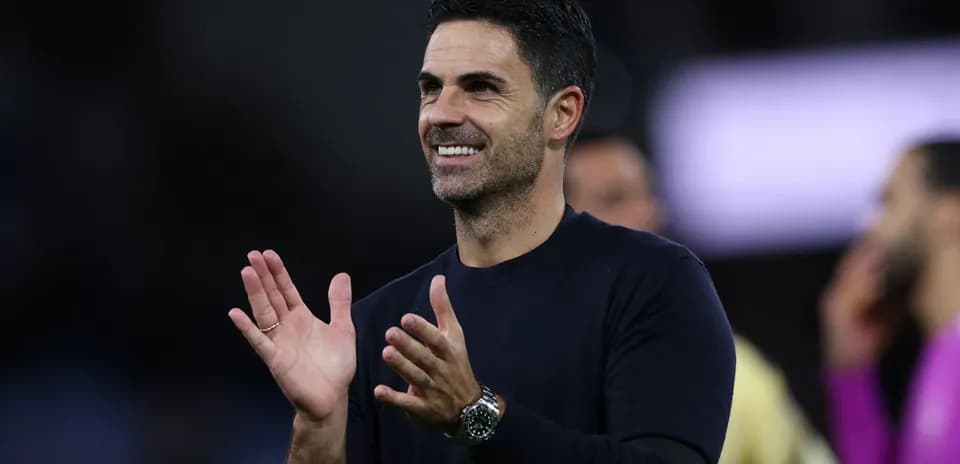 Coach clapping and smiling during match