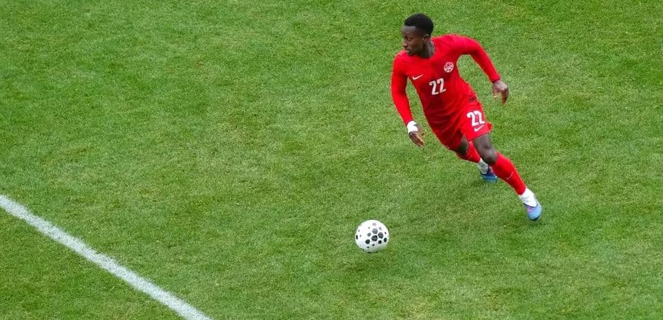 Canadian player running with the ball during match