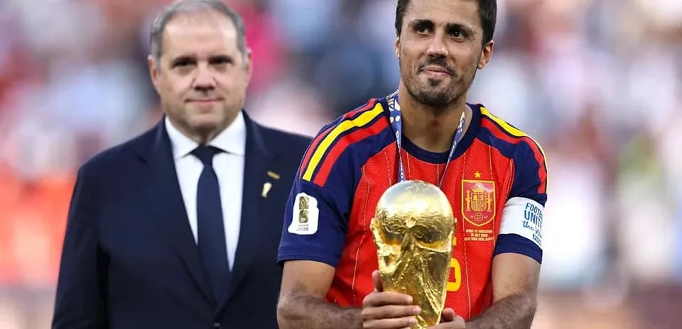 Player holding FIFA World Cup trophy on podium