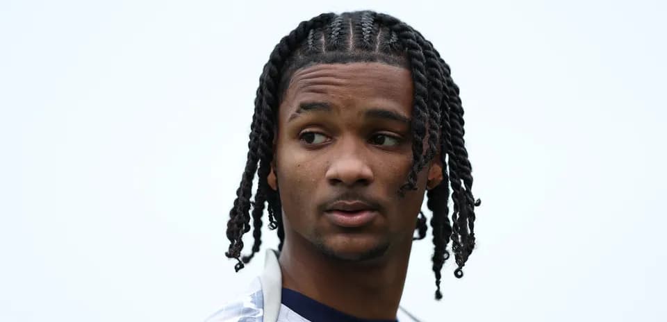 Player with braided hair looking away from camera