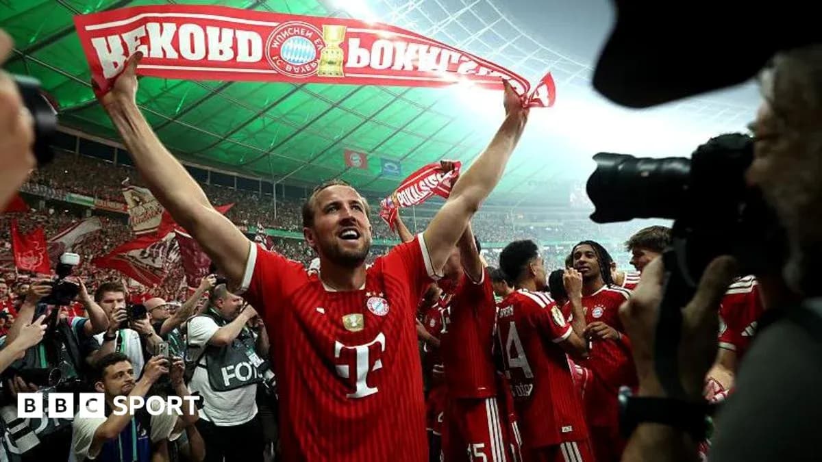 Player celebrating with fans holding a banner