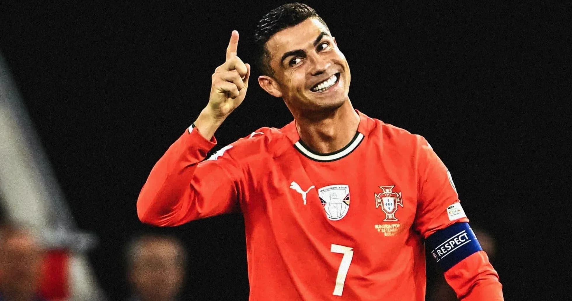 Player celebrating with finger raised in red jersey