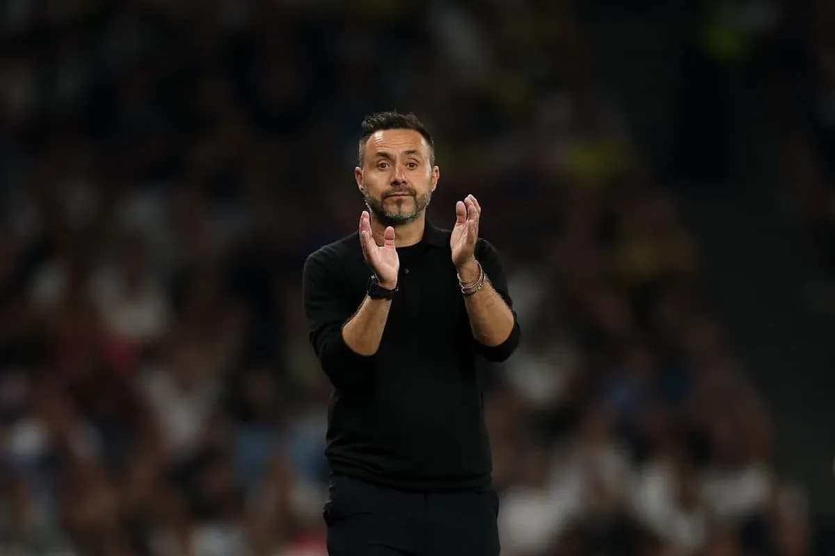 Manager applauding during a match on the sidelines