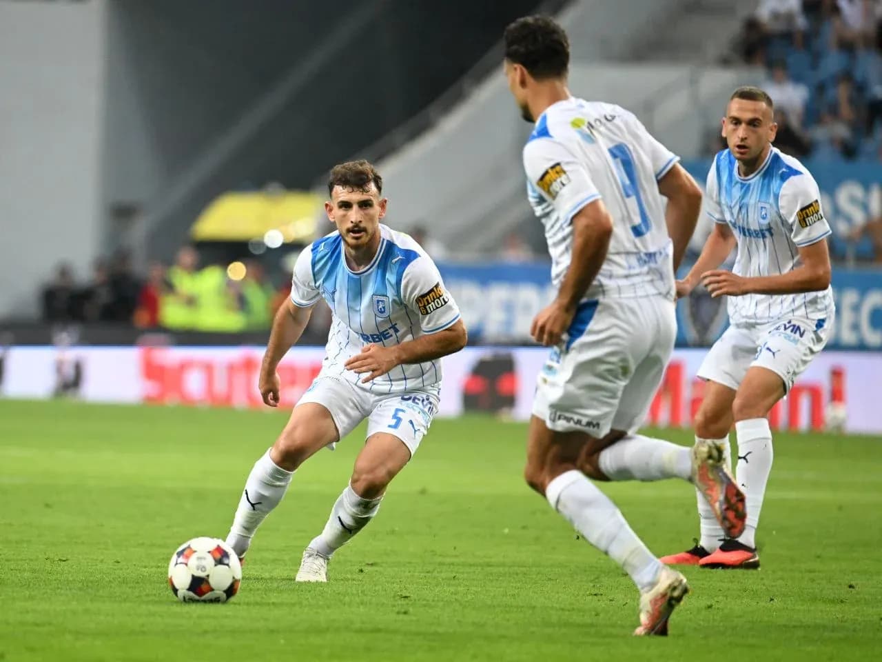Players from Universitatea Craiova during match action