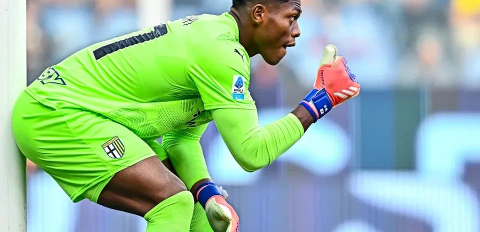 Goalkeeper in green kit signaling during match