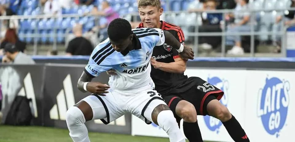 Players battling for the ball during MLS match