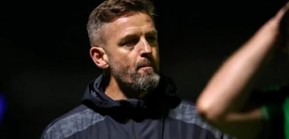Coach observing players during a training session