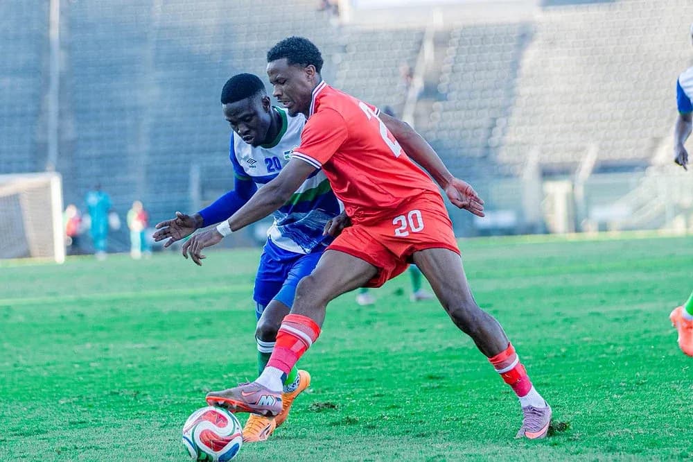 Two players competing for the ball on the field