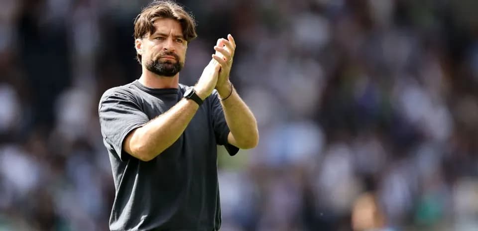 Coach applauding to the crowd after match