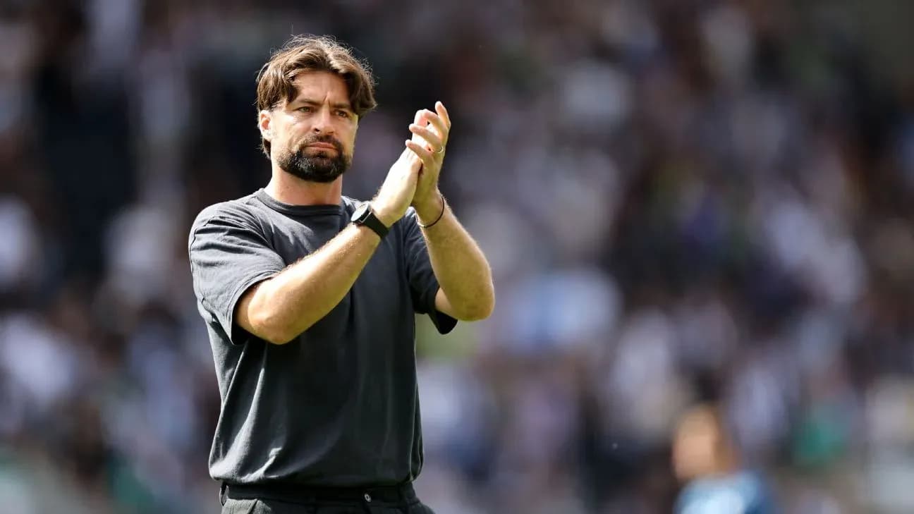 Coach applauding to the crowd after match