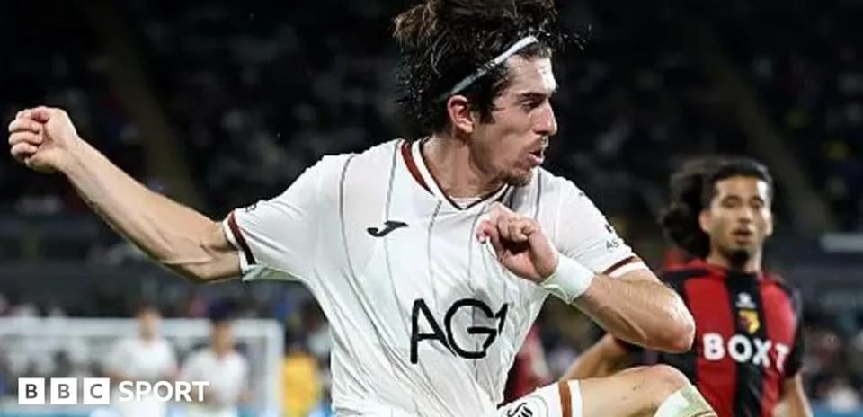 Player in white jersey executing a kick during match
