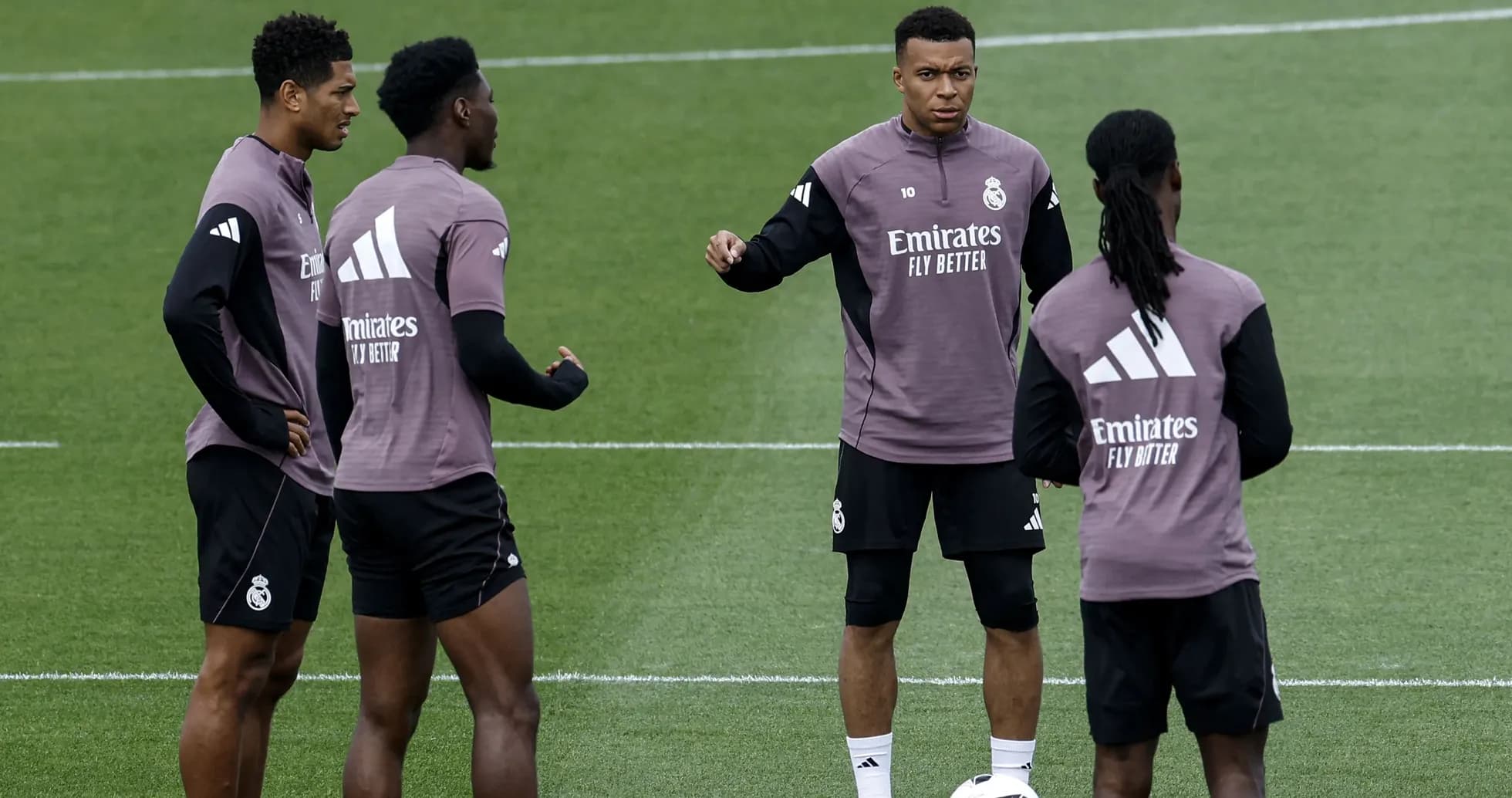 Four players discussing during Real Madrid training session