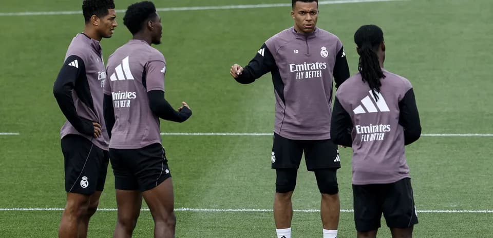 Four players discussing during Real Madrid training session
