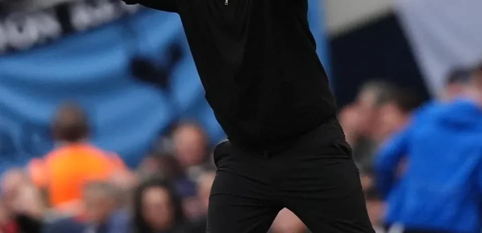 Coach gesturing during a football match on sidelines