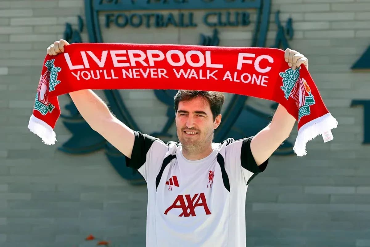 Man holding Liverpool FC scarf outside club building
