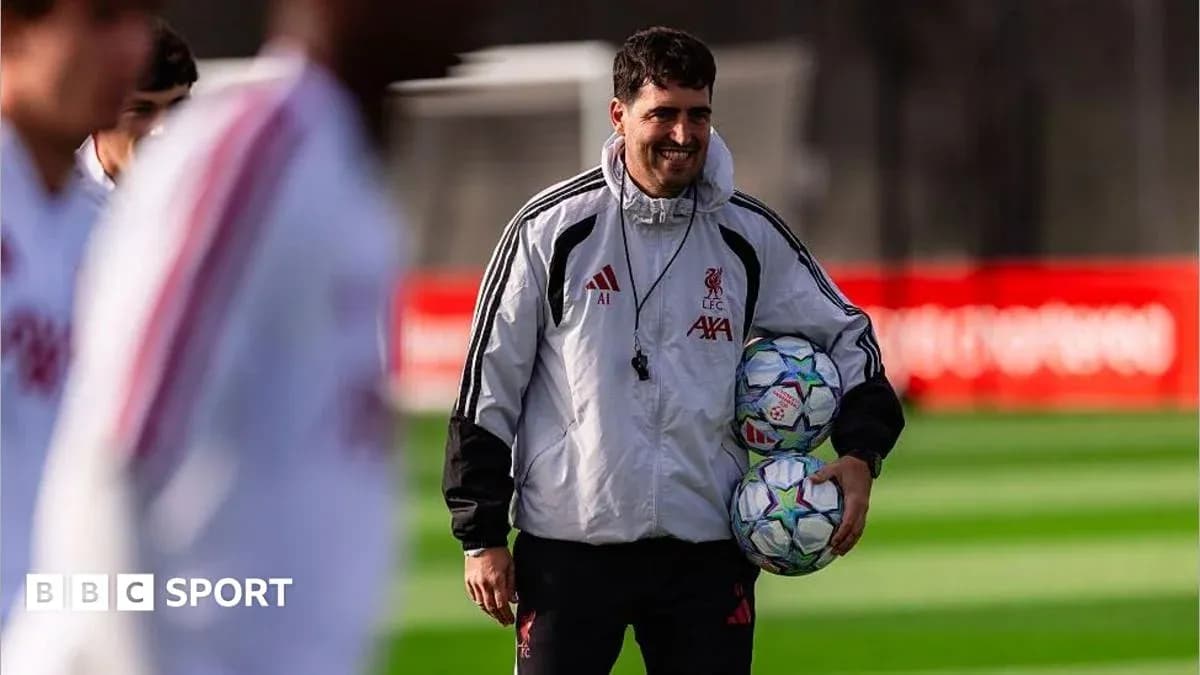 Coach holding footballs during training session