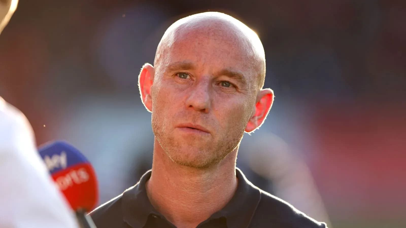 Manager being interviewed on the pitch