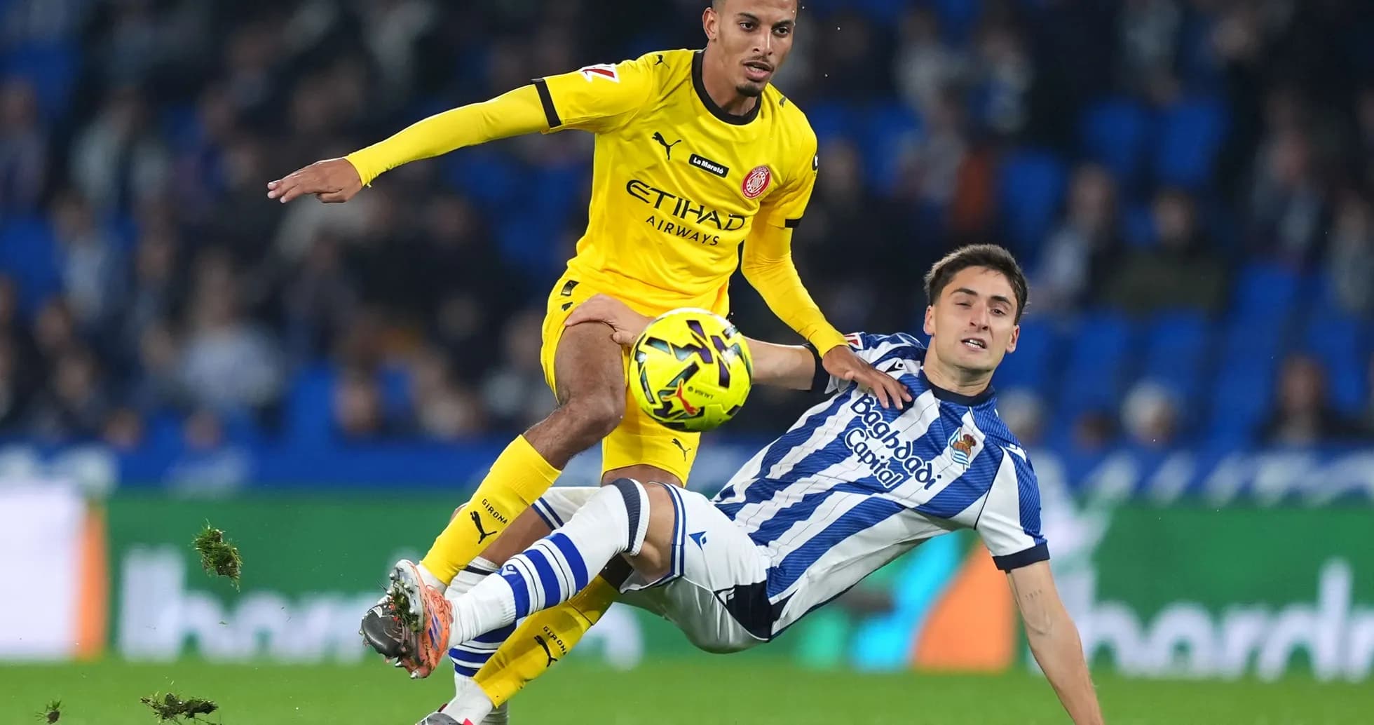 Girona player challenges Real Sociedad opponent
