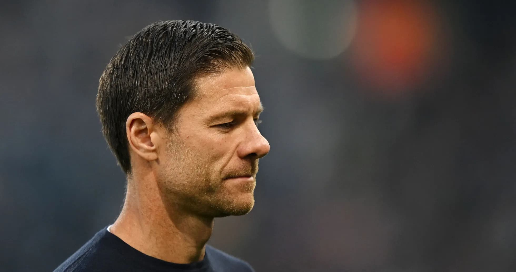 Coach looking thoughtful on the sidelines