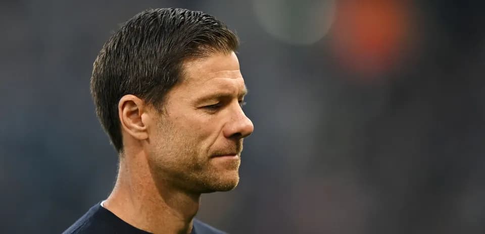 Coach looking thoughtful on the sidelines