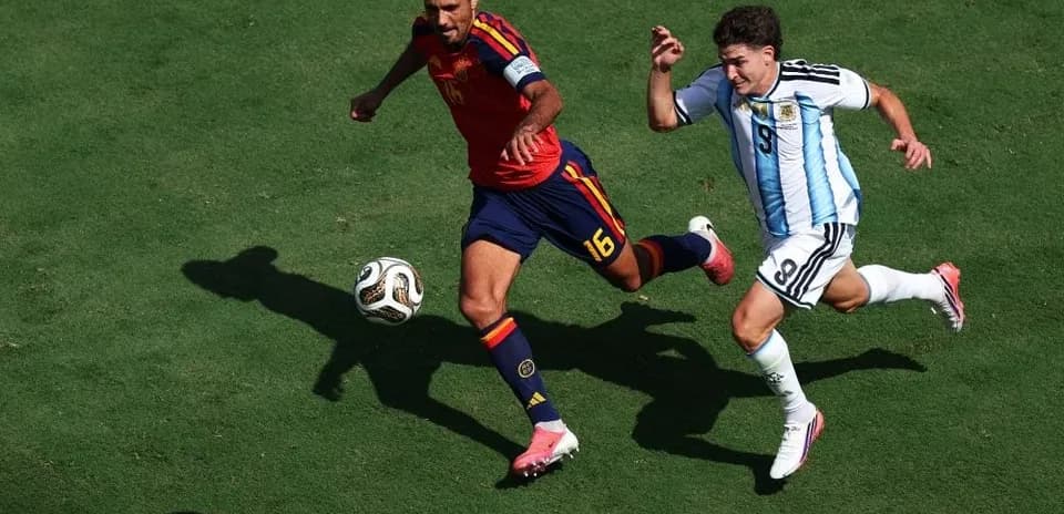 Two players chasing the ball during a match