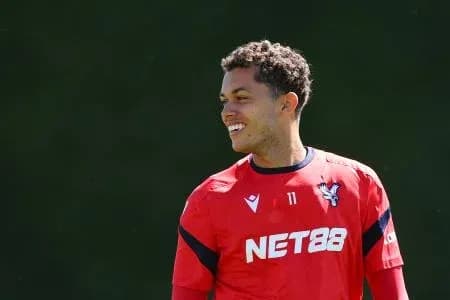 Player smiling during training session in red jersey