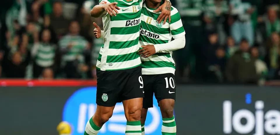 Two players celebrating on the pitch after scoring