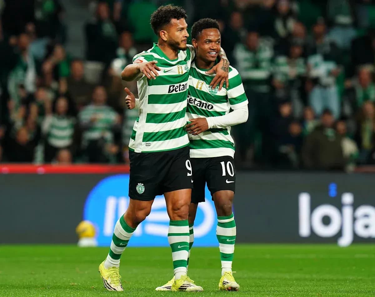 Two players celebrating on the pitch after scoring