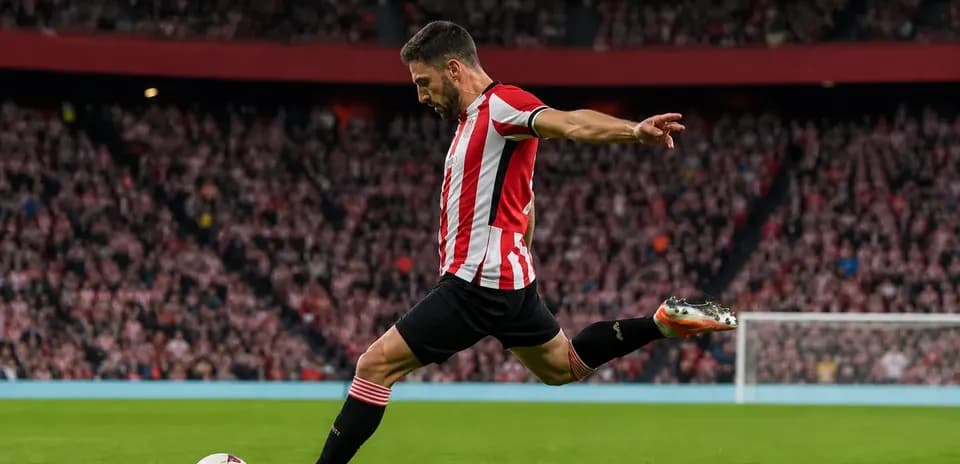 Player kicking ball during a football match