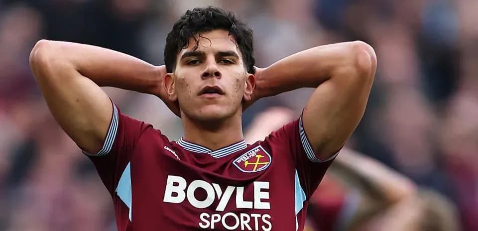 Player in West Ham kit with hands on head