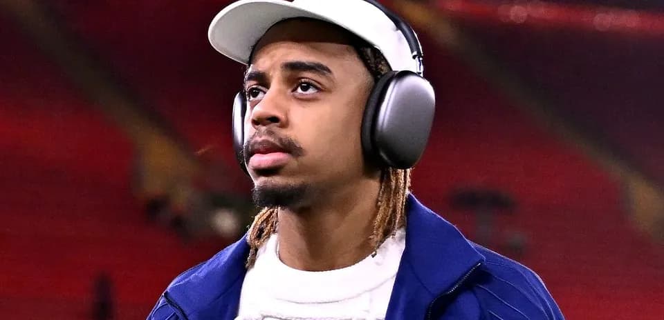 Player wearing headphones walking on the pitch