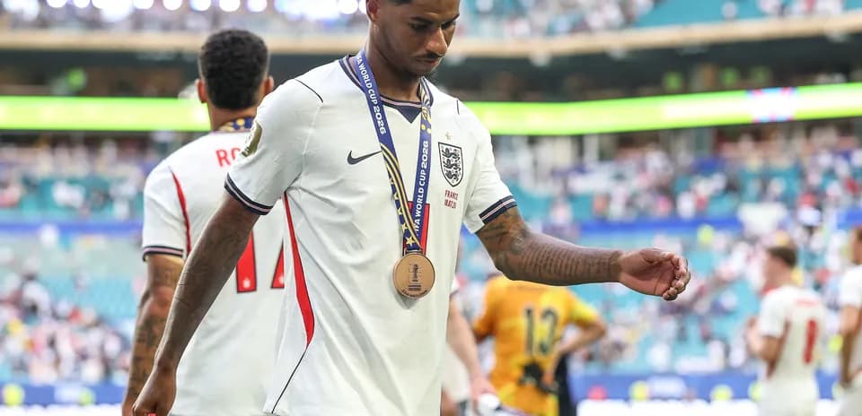 Player walking off field with bronze medal after match