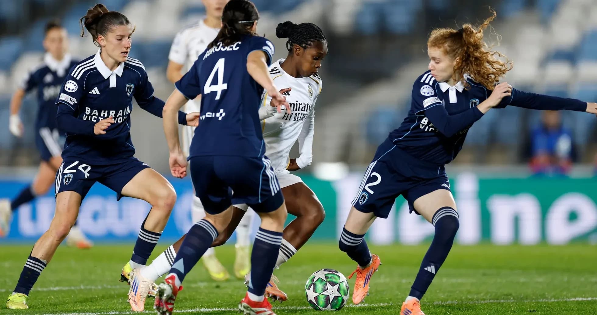Real Madrid player dribbling past Paris FC defenders