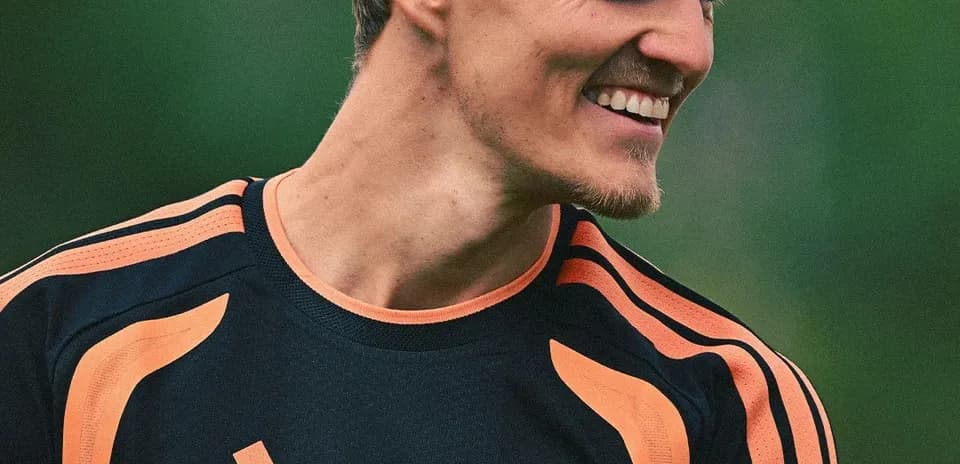 Player smiling during training session in Arsenal kit