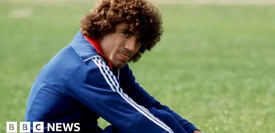 Football player sitting on grass during training