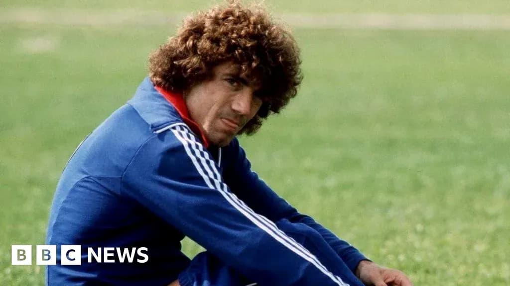 Football player sitting on grass during training