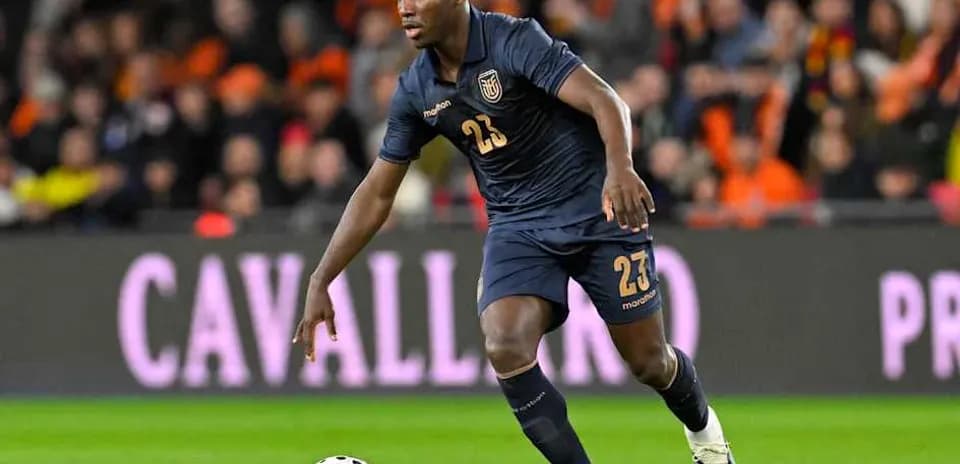 Player in dark jersey dribbling ball during match