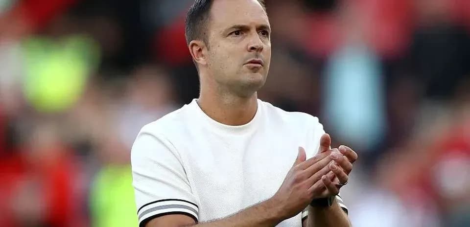Coach applauding during a match at the stadium