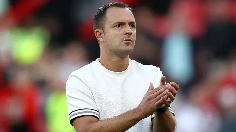 Coach applauding during a match at the stadium