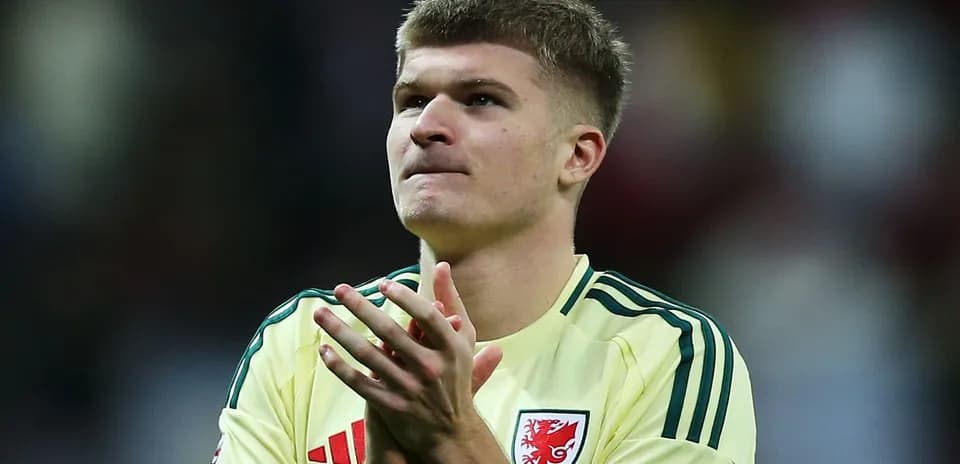 Player applauding fans in yellow kit