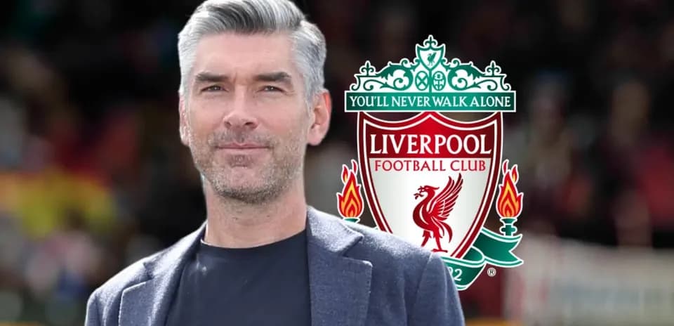 Man in front of Liverpool FC logo backdrop