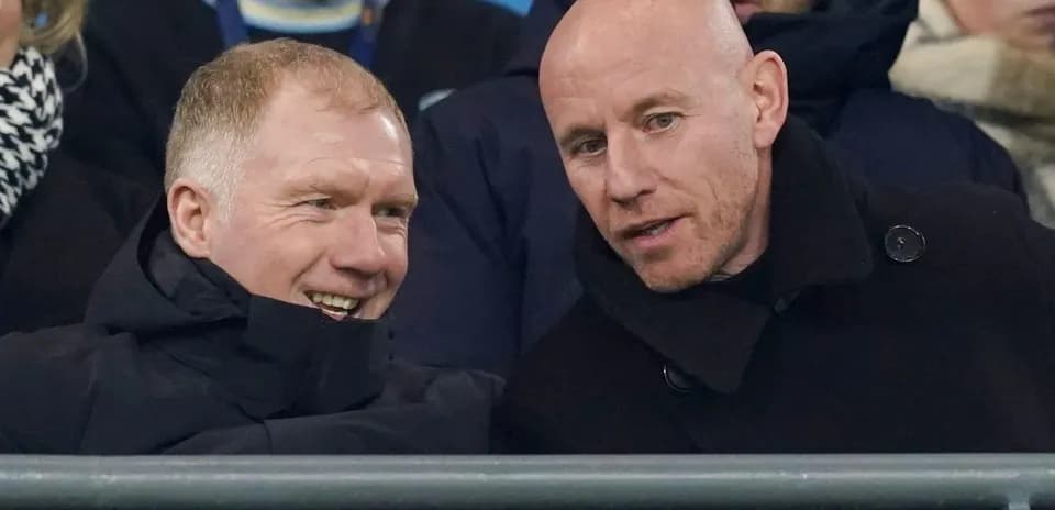 Two men chatting in stadium seats during match